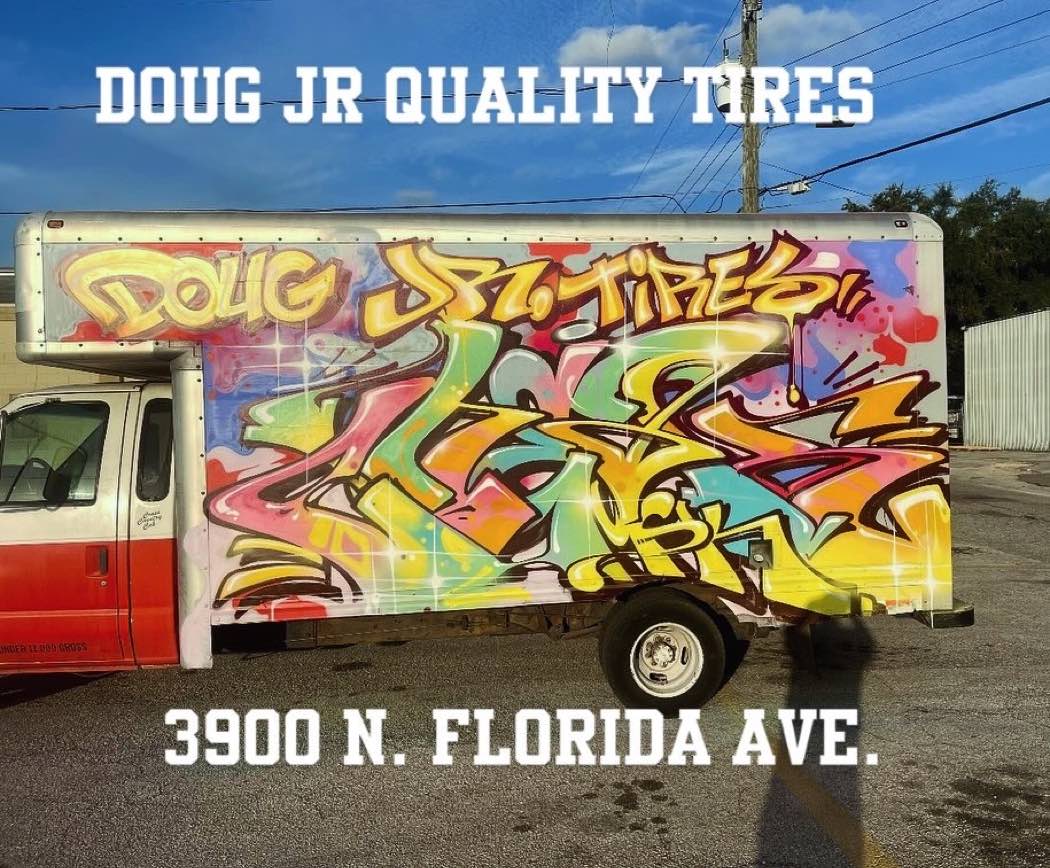 Doug Jr Quality Tires graffiti-wrapped shop truck reading 3900 N. Florida Ave.