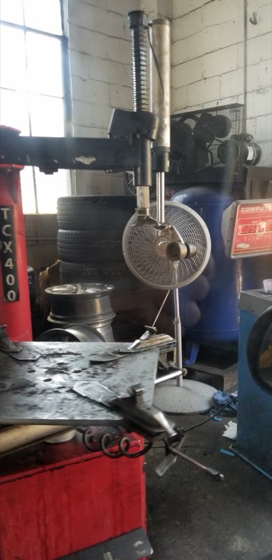 Tire-mounting machine and wheel balancer inside the shop